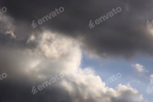 Preview: Dark Clouds In Sky With Sun Ray - Photograph Of Some Late Afternoon Gray And White Clouds In A Blue