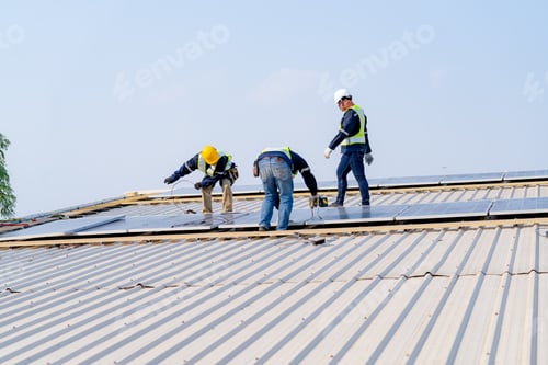 Preview: workers installing solar panels, for efficient energy on rooftop