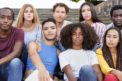 Preview: Group of diverse friends sitting in the city and looking serious on camera