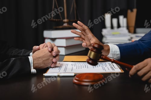 Preview: young businessman and Lawyer or legal advisor sitting at office holding hammer of justice with busin