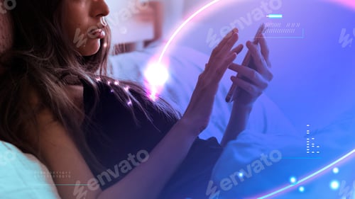Preview: Woman playing on her phone in bed