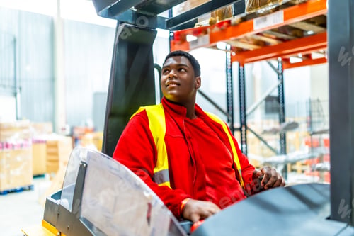 Preview: Migrant worker in a warehouse driving a forklift