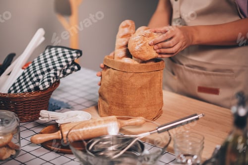 Preview: Delicious Homemade Bakery: Small Business Owner Packing Fresh French Baguettes for Customers