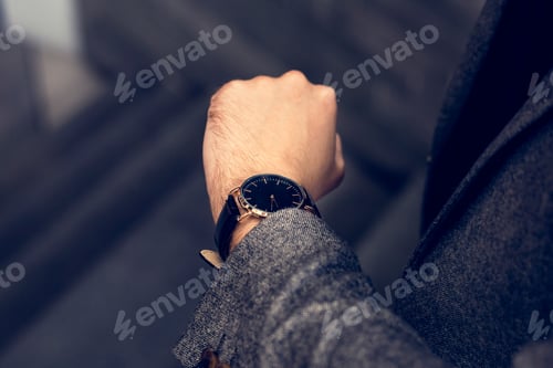 Preview: Man looking at his watch