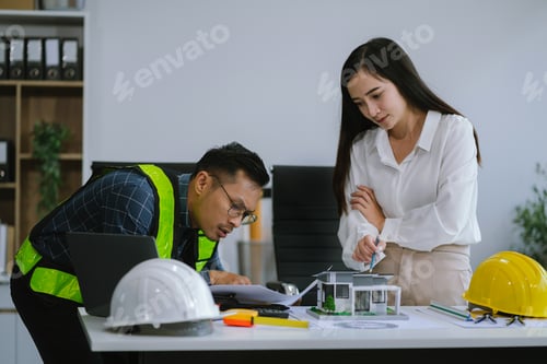 Preview: Architects Reviewing House Design in Office