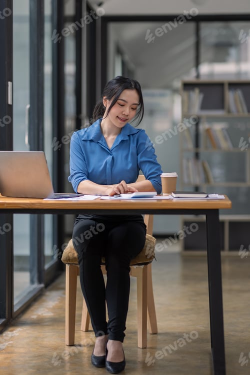 Preview: Asian Business woman using calculator and laptop for doing math finance on an office desk, tax, repo