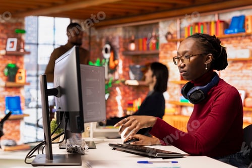 Preview: Programmer in startup office using large language model to get help with coding