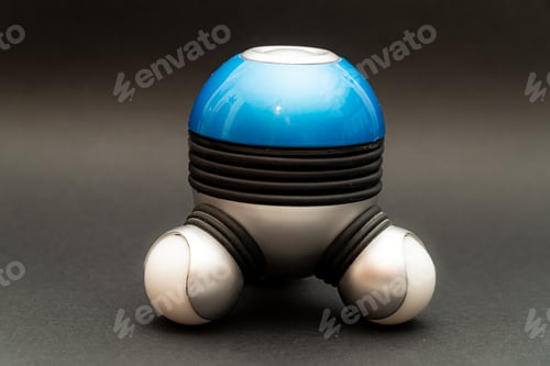 Preview: Closeup of a battery-operated handheld massager isolated in the dark gray background