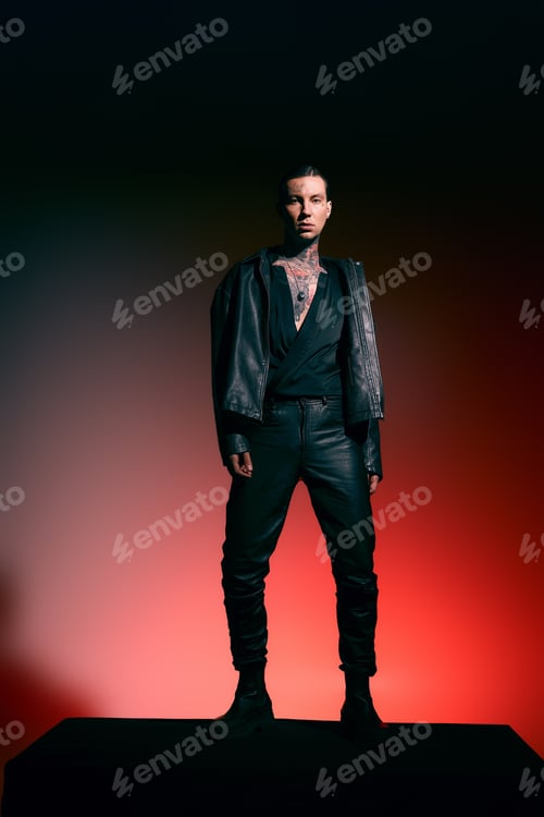 Preview: Stylish young man showcases bold fashion in dramatic lighting against a stunning backdrop