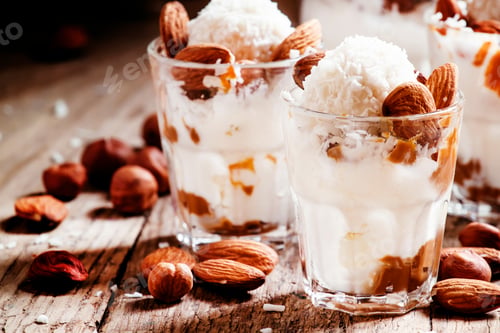 Preview: Dessert with vanilla ice cream, nut sauce, almonds, hazelnuts and coconut