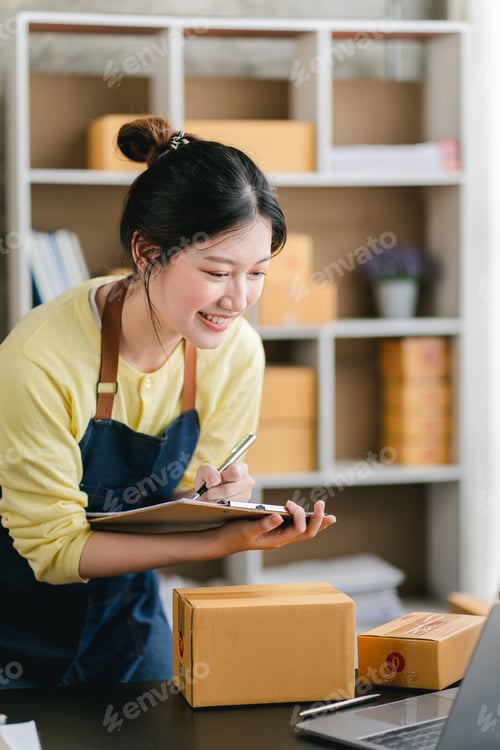 Preview: Portrait of a small business startup, SME owner, female entrepreneur, working, unboxing, checking or