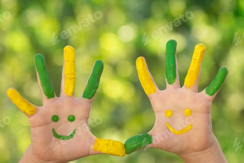 Preview: Happy child with smile on hands against green spring background