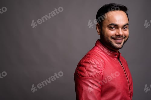 Preview: Young bearded Indian man against gray background