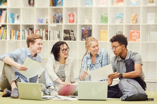 Preview: Young students discussing in library