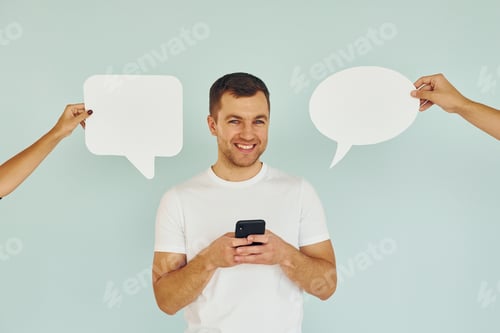 Preview: Conversation text. Man standing in the studio with empty signs