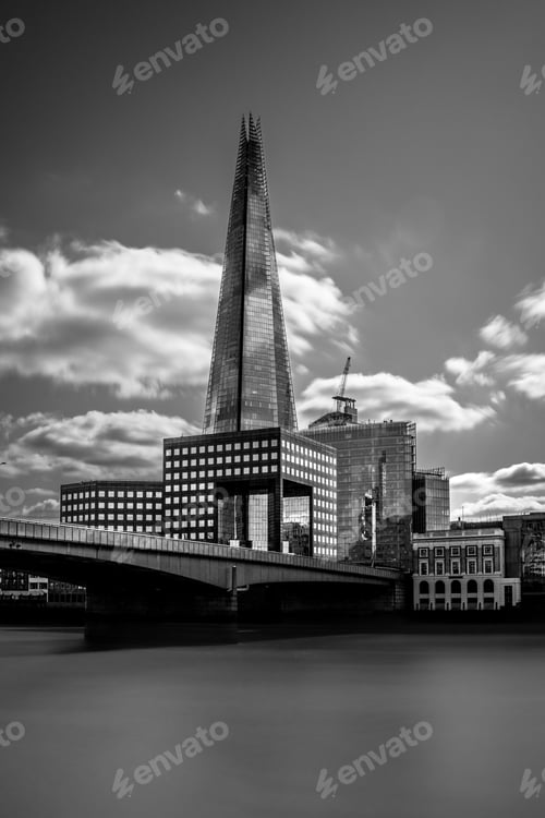 Preview: Black and white photo of The Shard in London, with dramatic clouds and modern architecture