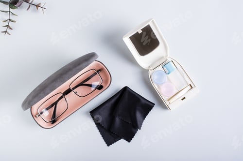 Preview: Glasses in a case, a set for contact lenses and a cloth. Сhoosing a method of vision correction.