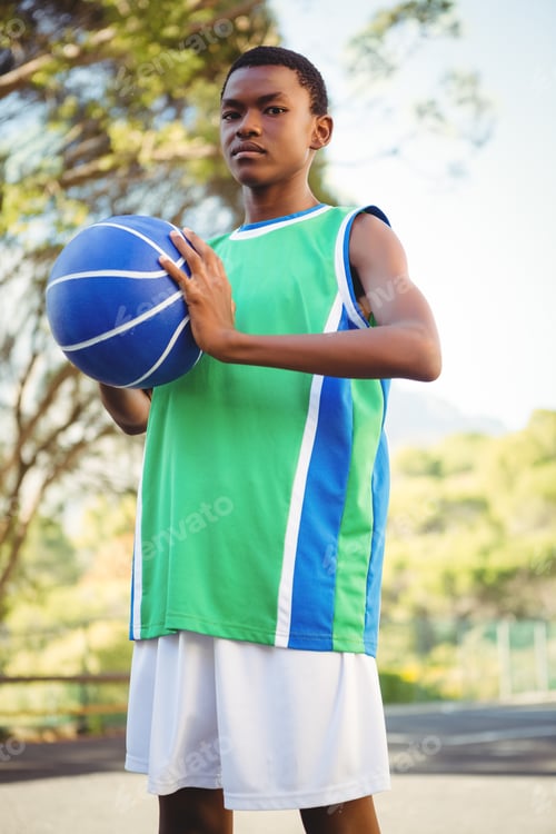 Preview: Portrait of teenage boy with basketbal