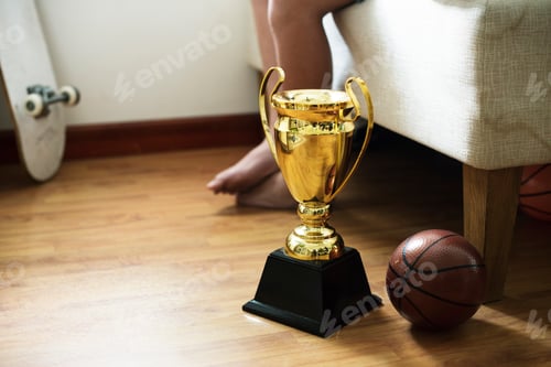 Preview: Closeup of trophy on the bedroom floor with basketball