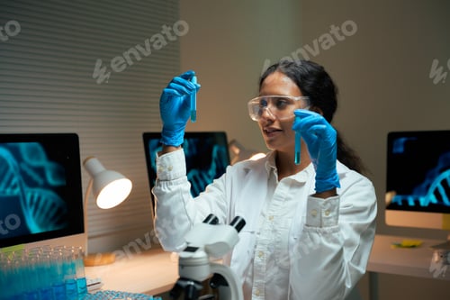 Preview: Female scientist analyzing DNA samples in laboratory