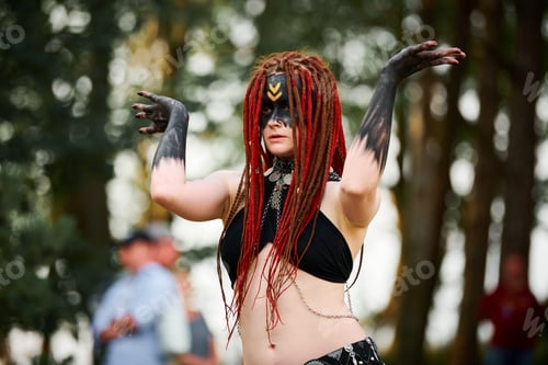 Preview: Mythological dancing girl faun on green lawn in public park outdoor art dancing event