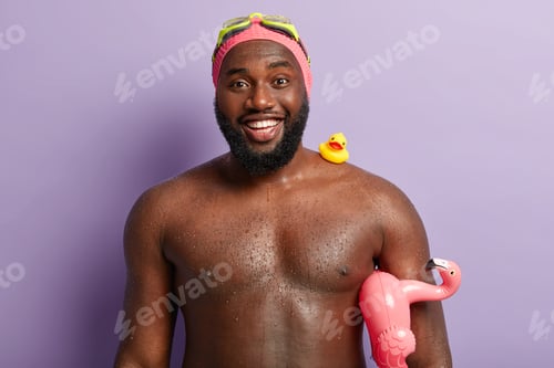 Preview: Candid shot of smiling dark skinned guy with toothy smile, has white teeth, enjoys swimming and summ