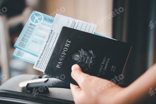 Preview: People holding passports and Coronavirus vaccination record card