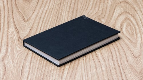 Preview: Black book on wooden table