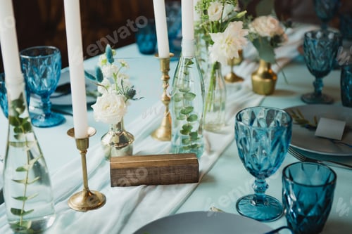 Preview: Table setting at the wedding reception. Floral compositions with beautiful flowers and greenery, can