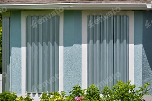 Preview: Steel sheets mounted as storm shutters for hurricane protection of house windows