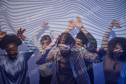 Preview: Diverse group of young people dancing in graphic neon lights