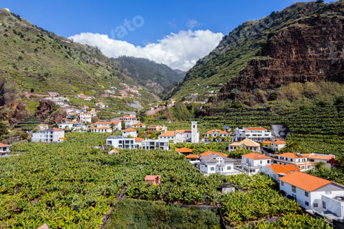 Preview: Aerial view of small farming village with banana plantation at Madeira Atlantic Ocean coast