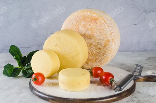 Preview: Assorted tasty cheese of different kinds and sizes on table.