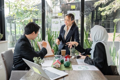 Preview: Professionals brainstorming sustainable approaches in a modern workplace.