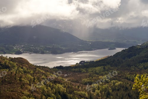 Preview: Beautiful landscape of a Norwegian fjord with a dramatic cloudy sky in the background, Norway