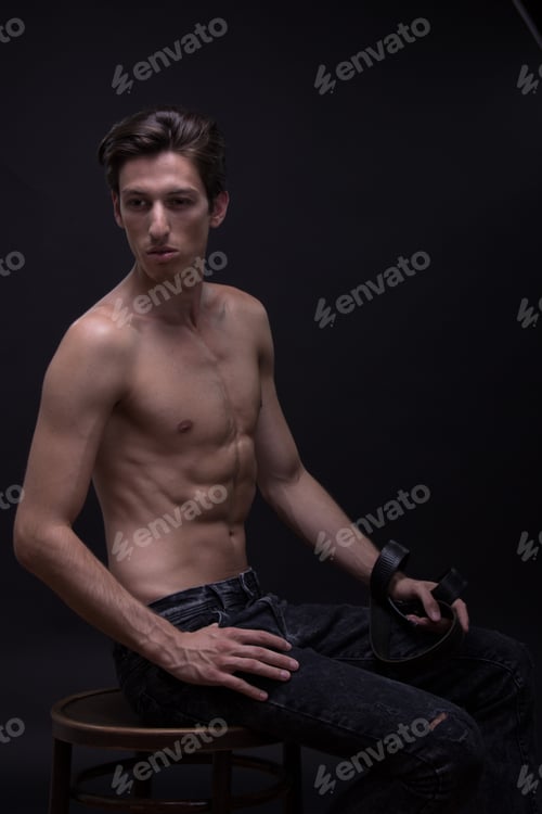 Preview: Nude Young Man Caucasian Skinny, Slim, Fit Abs, Tanned Skin Jeans. Black Background Low Key.