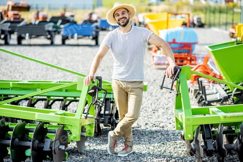 Preview: Agronomist at the shop ground with agricultural machinery