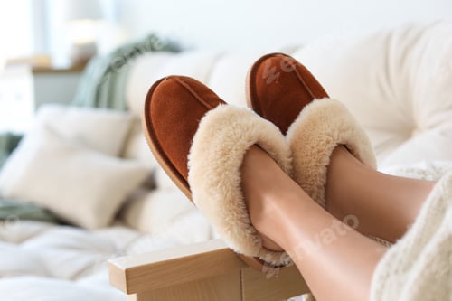 Preview: Woman wearing soft comfortable slippers at home, closeup
