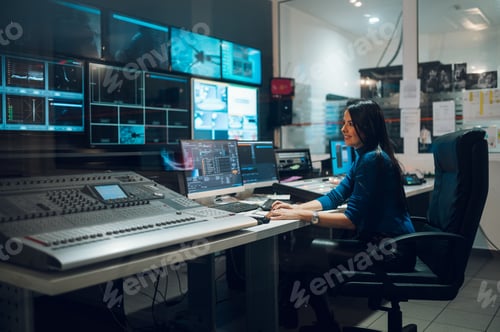 Preview: Middle aged woman using equipment in control room on a tv station