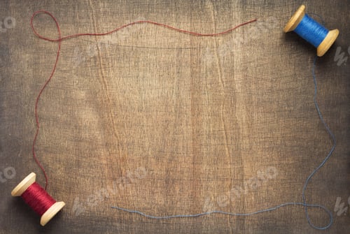 Preview: sewing thread on wooden table