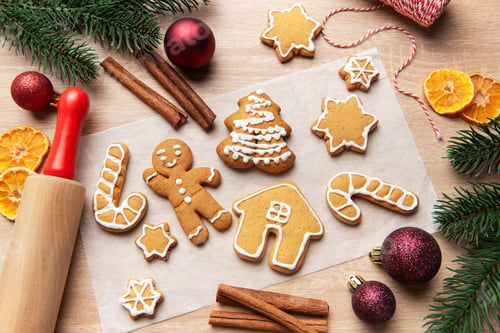 Preview: Homemade gingerbread cookies on baking paper for christmas