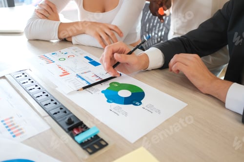 Preview: Business Professionals Reviewing Charts at a Meeting