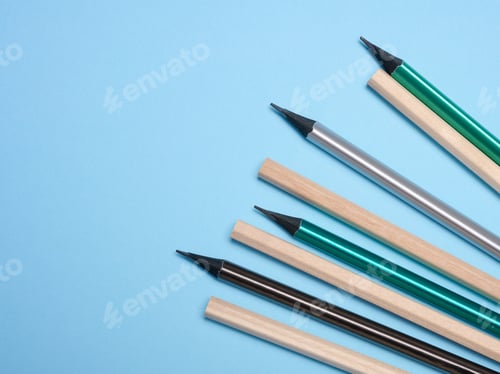 Preview: Wooden pencils on a blue background, top view