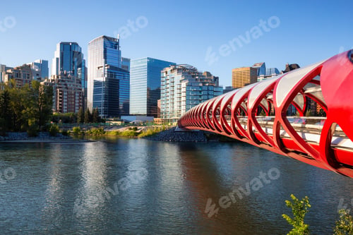 Preview: Peace Bridge across Bow River during a vibrant summer sunrise