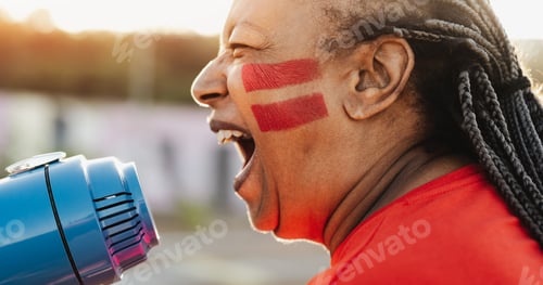 Preview: African football fan with painted face and megaphone cheering for her team