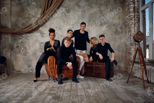 Preview: Portrait of overjoyed happy millennial gen z diverse multiethnic friends relax on sofa have fun