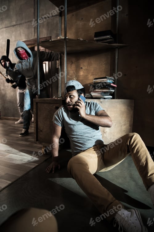 Preview: Scared man hiding from burglars breaking indoors, house robbery scene