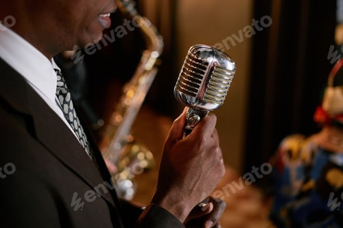 Preview: Black Male Singer Holding Classic Mic Performing Jazz Song with Band Indoors