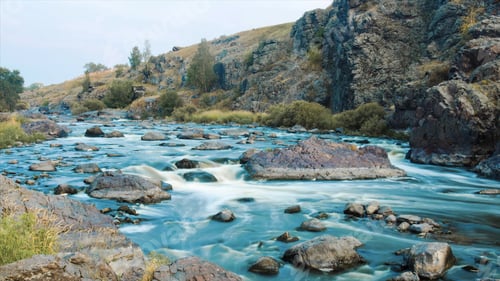 Preview: Beautiful River water flowing through stones and rocks at dawn. Video. Flow of the river through the