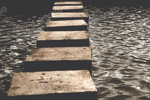 Preview: Stepping Stones Crossing Still Water in Natural Setting